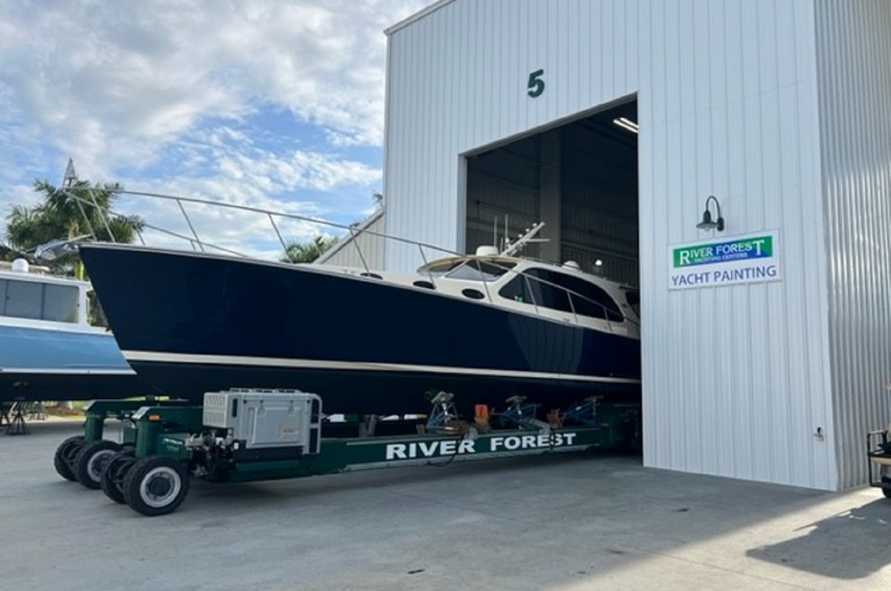 yacht-coming-out-of-paint-booth-boat-painting-River-Forest-Yacthing-Centers-of-Labelle-and-Stuart-Fort-Myers-Cape-Coral.